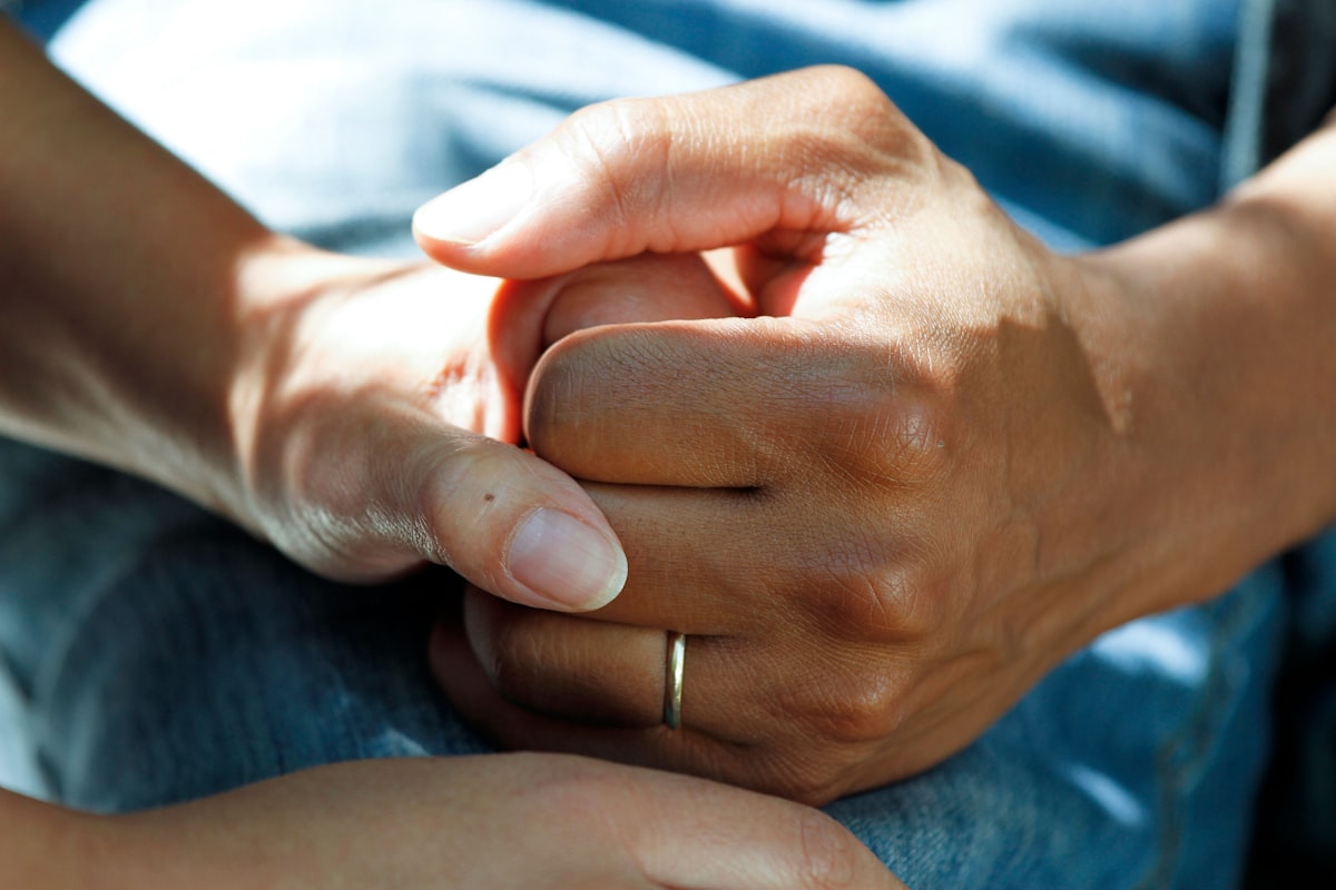 Close-up of human hands with visible swelling in the finger joints and knuckles.