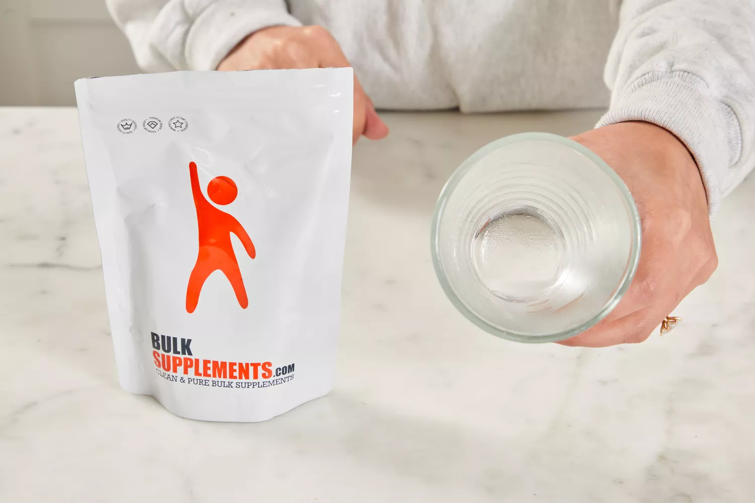 A white pouch of BulkSupplements.com powder on a kitchen counter.