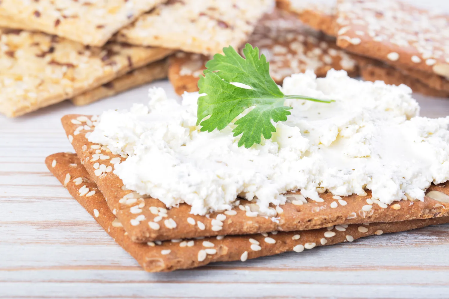 Plain whole grain crackers with a thin layer of low-fat cheese spread.