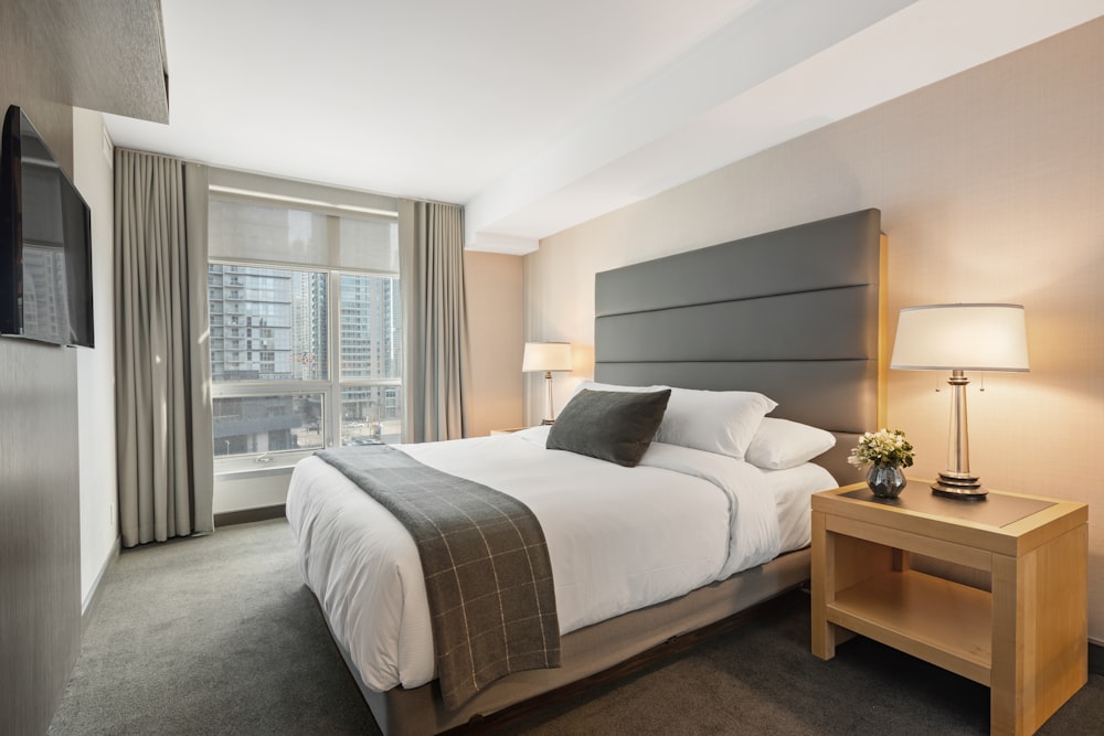 A clean, modern bedroom with a high-quality mattress and neutral bedding.