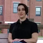 A woman sitting on a bench outdoors, illustrating a moment of sedentary behavior.