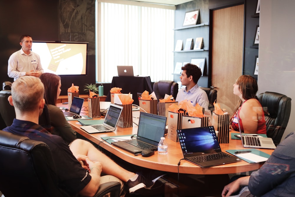 A group of human resources professionals in a conference room discussing workplace policies.