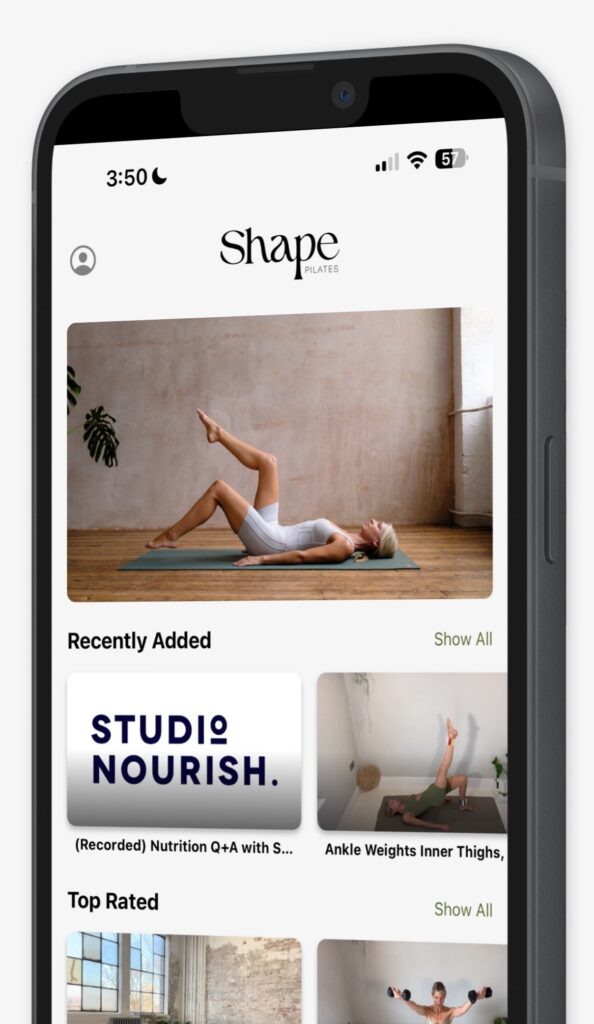 A serene Pilates setup featuring a mat and light hand weights in a bright room.