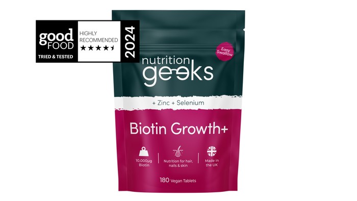 A bottle of Nutrition Geeks Biotin Growth Plus supplements.