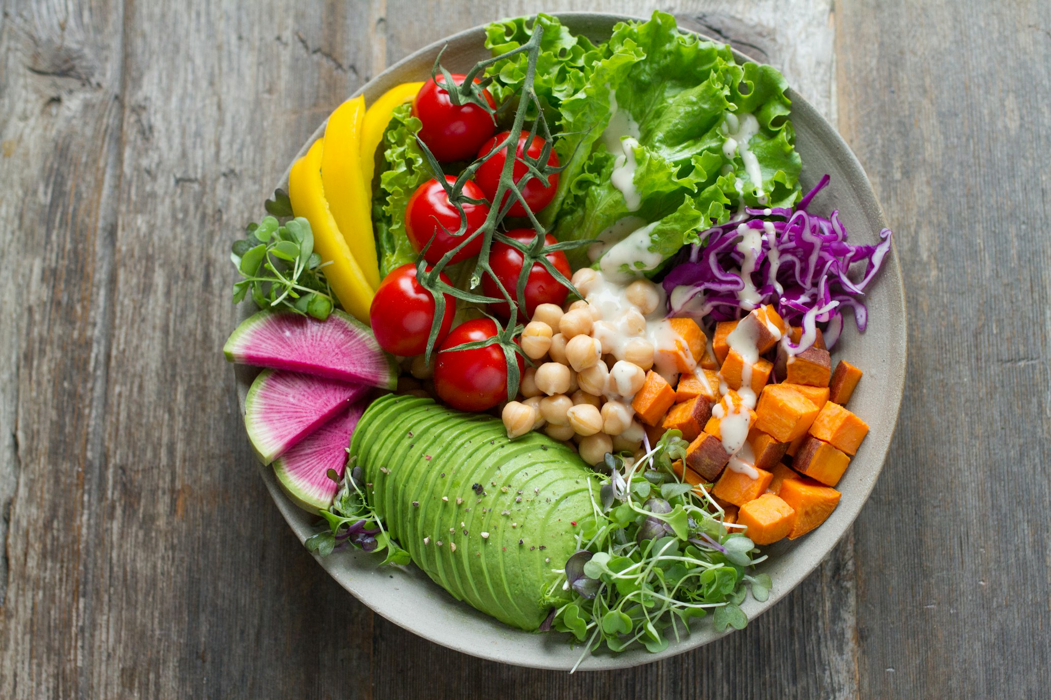 A collection of fiber-rich fruits and vegetables including broccoli, peppers, and apples.