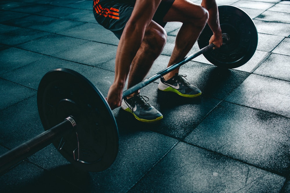 A person lifting a kettlebell to perform resistance training exercises.
