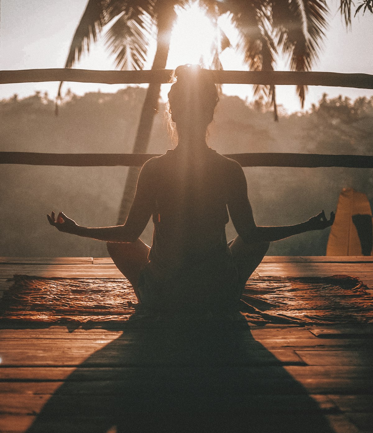 A person sitting in a peaceful bedroom setting practicing calm breathing exercises.