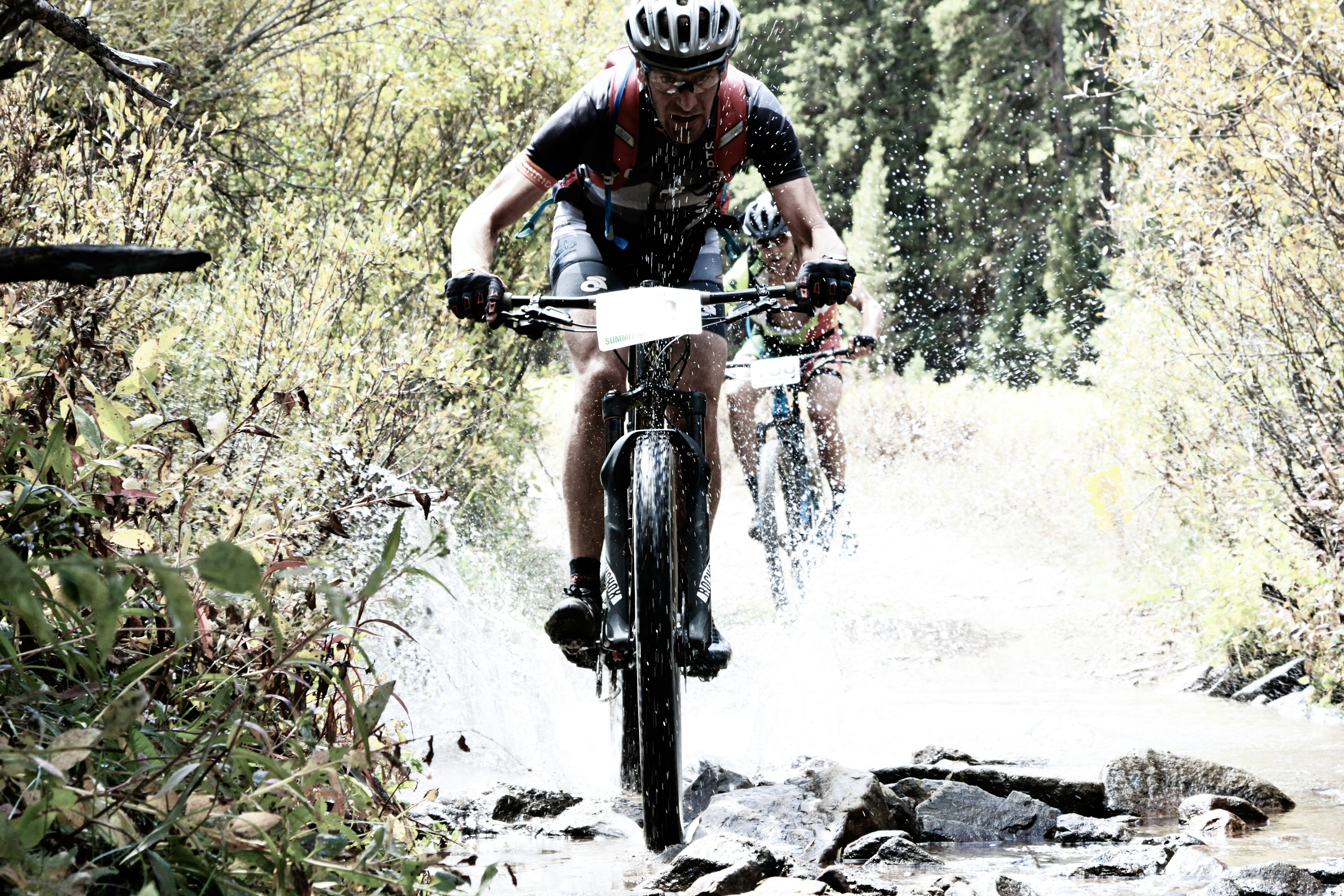 A professional cyclist riding a road bike on a clear day.