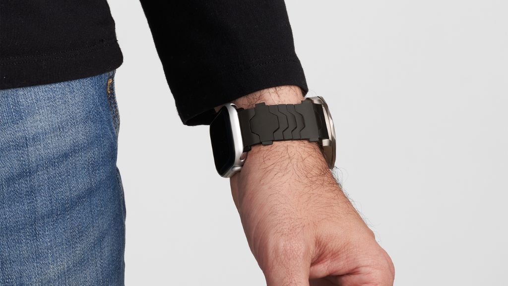 A person wearing a smartwatch positioned higher up the wrist for better sensor contact.