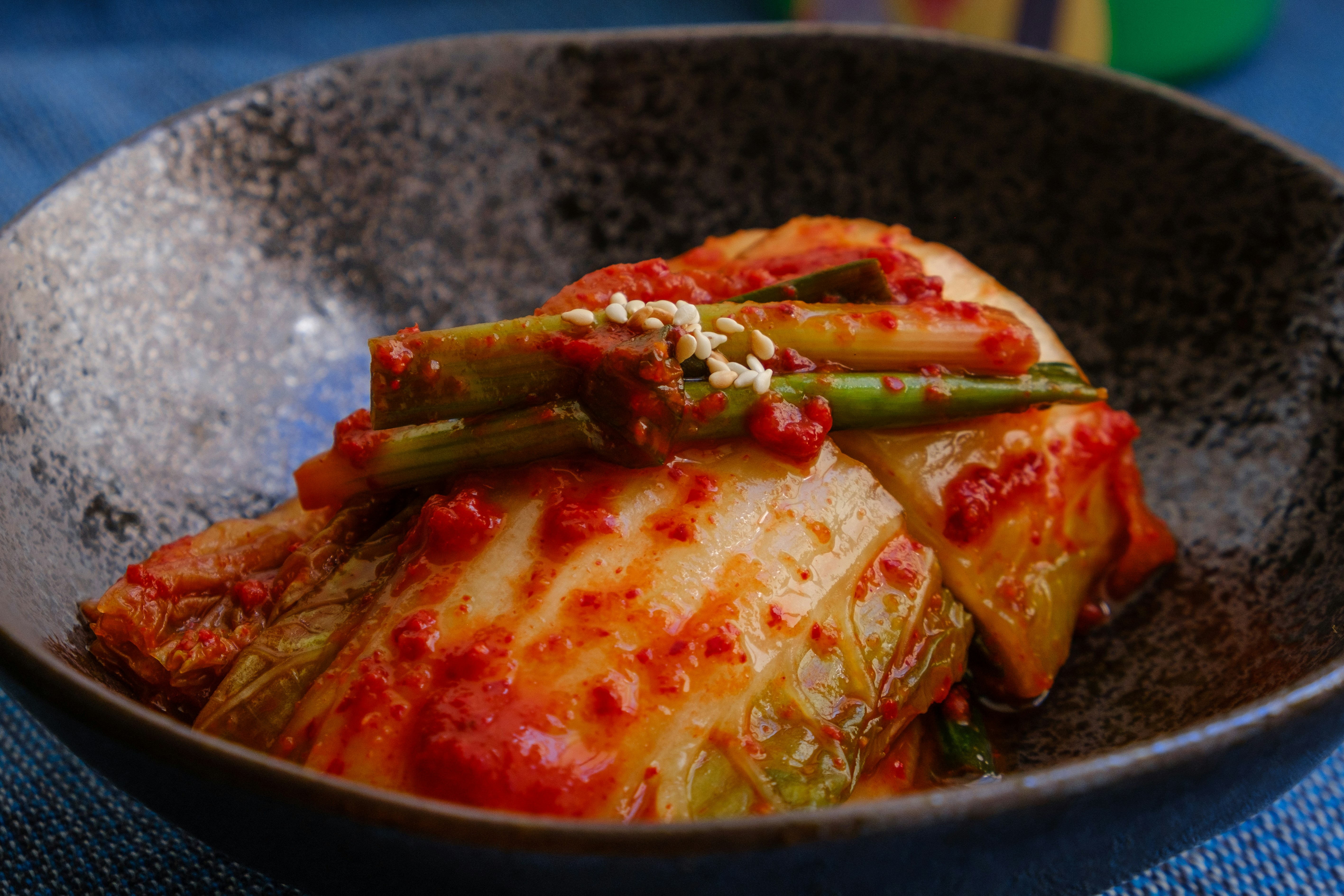 A close-up shot of spicy traditional fermented cabbage kimchi in a bowl.