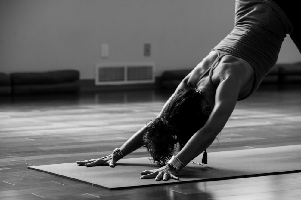 A woman practicing core-focused exercises on a reformer carriage with proper alignment.