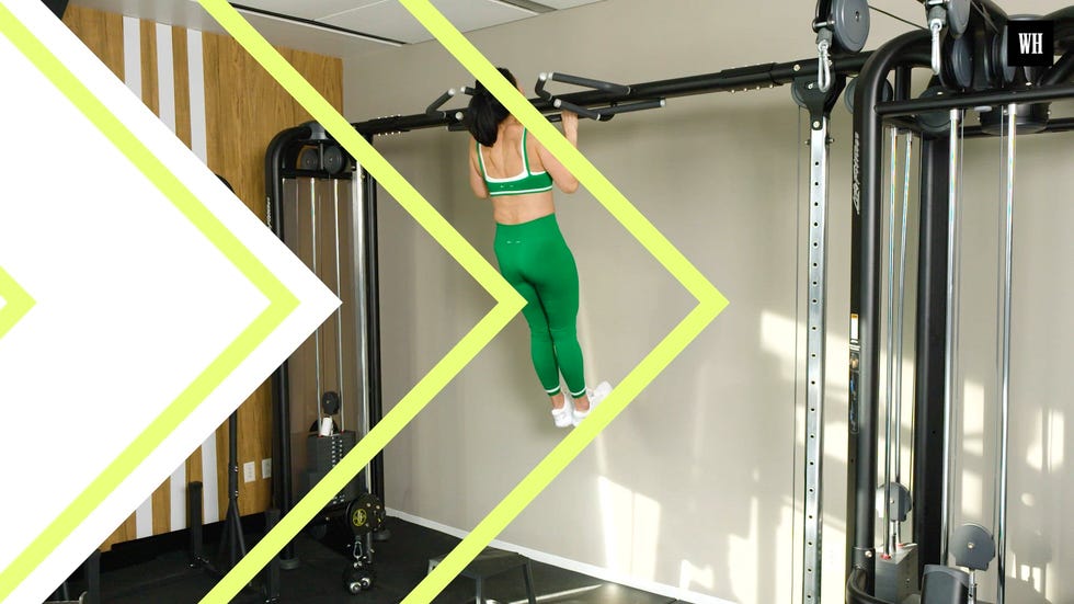 A woman performing a high-intensity functional workout in a gym setting.