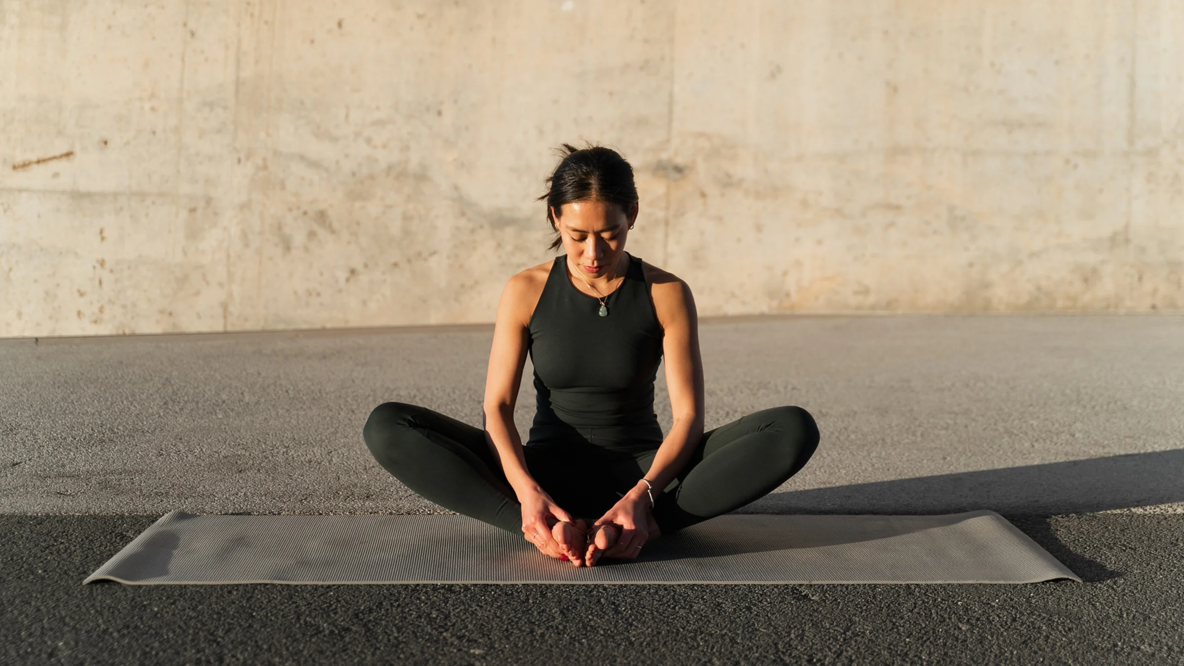 A woman performing a seated butterfly stretch to improve blood circulation in the pelvic region.