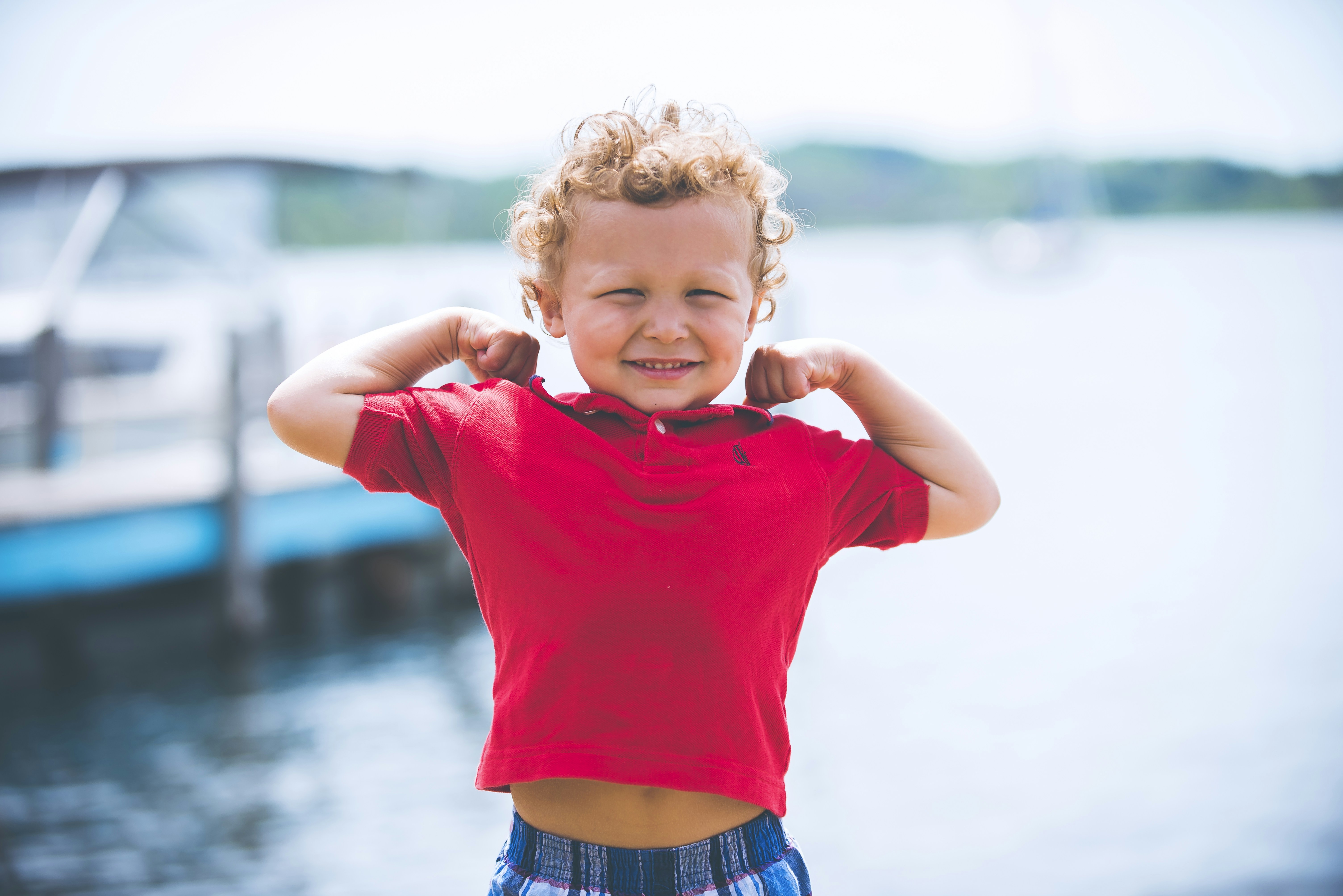 A child playing outside in bright, natural morning sunlight.