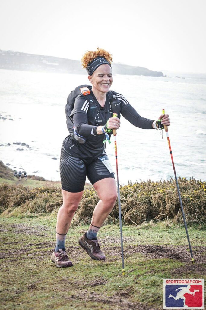 Sabrina Pace-Humphreys maintaining a steady pace on a scenic trail outdoors.