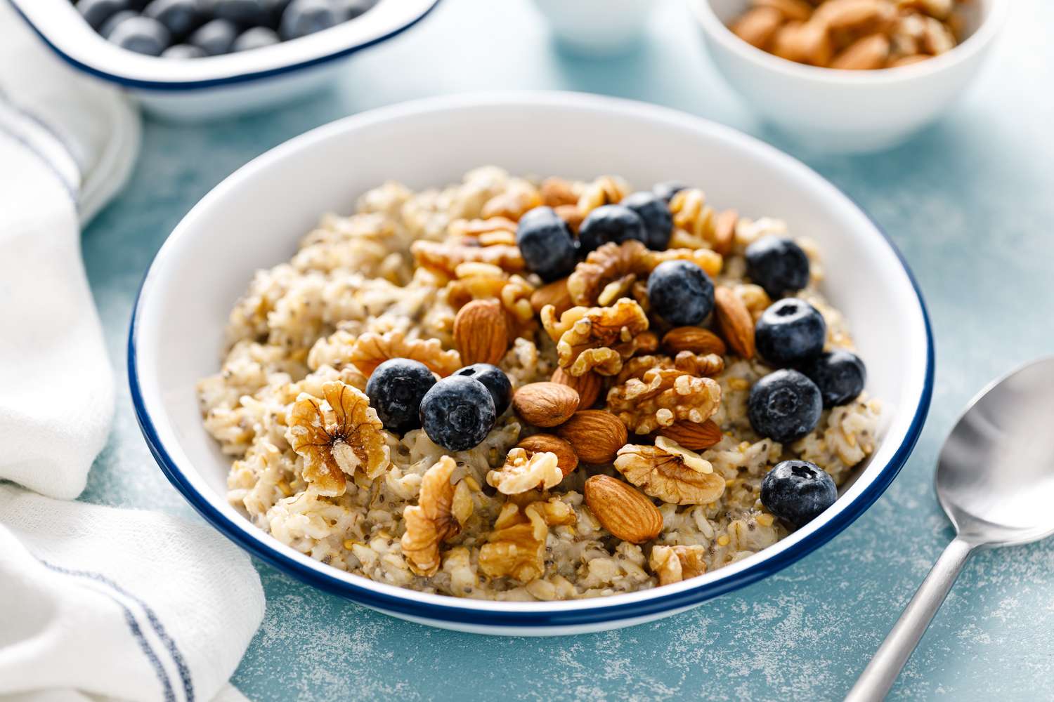 A healthy breakfast bowl featuring oatmeal topped with fresh blueberries and nuts.