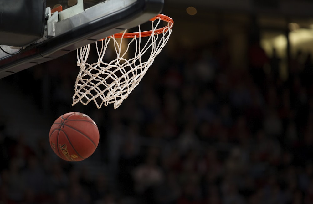 A basketball player jumping high for a shot to demonstrate explosive power.