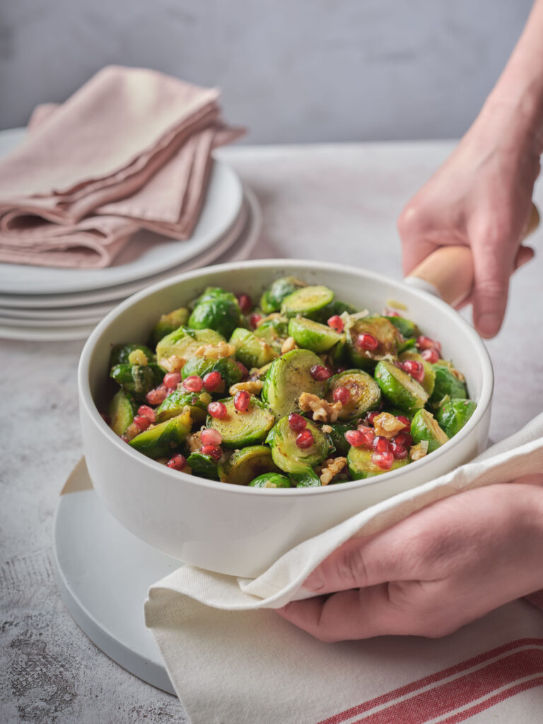 Oven-roasted Brussels sprouts with visible caramelized edges and mixed toppings.
