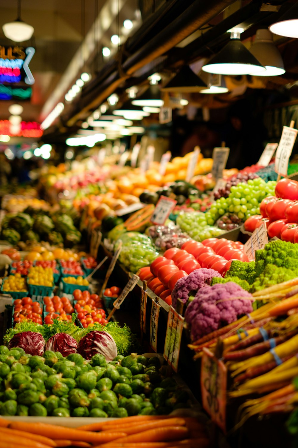 A wide variety of colorful fresh vegetables spread across a wooden table.