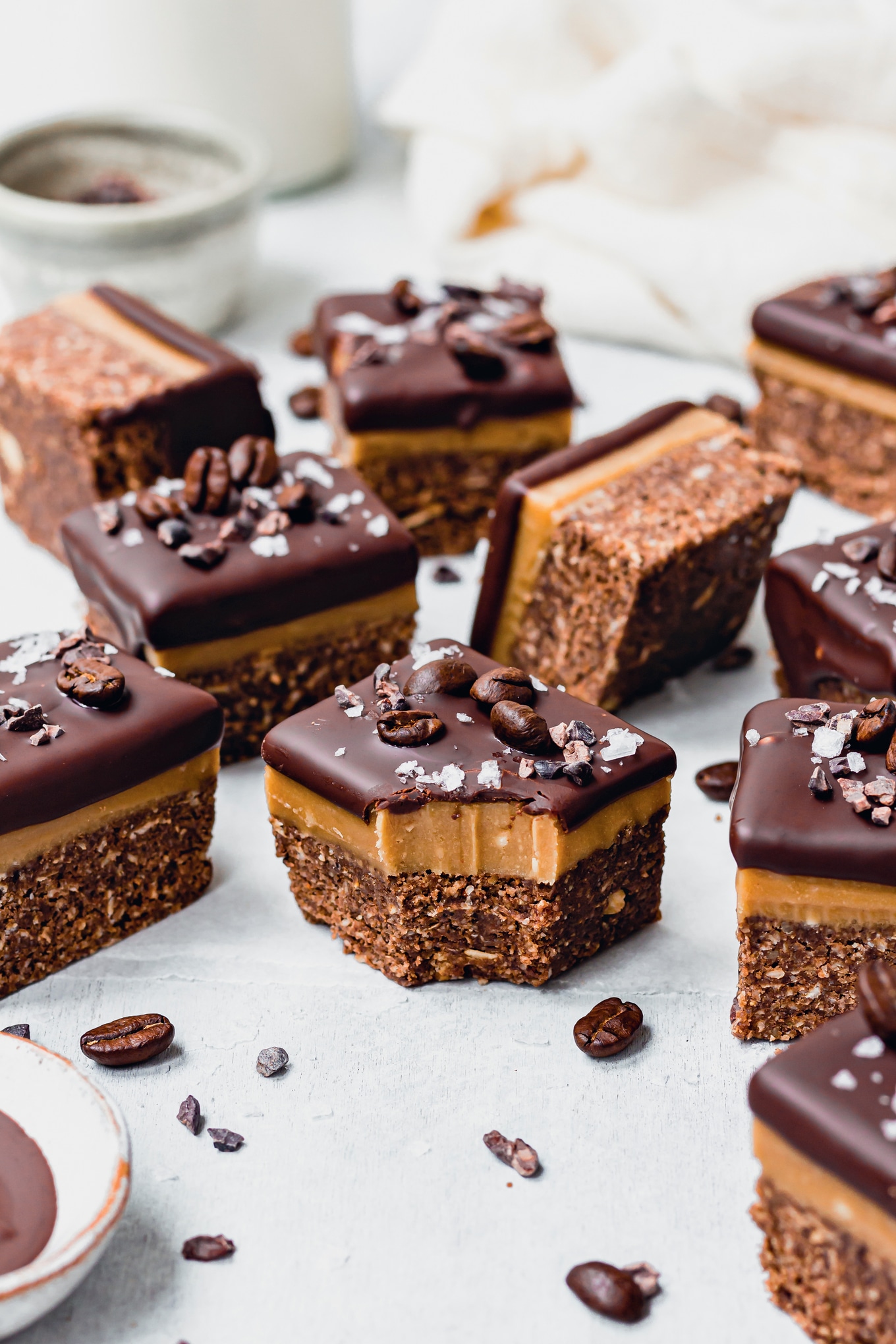 Close-up side view of a vegan espresso bar highlighting the biscuit, caramel, and chocolate layers.