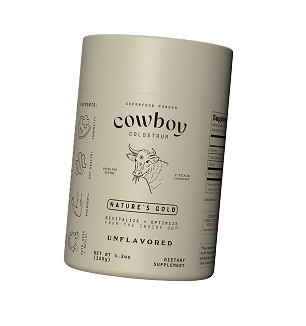 Close-up detail of Cowboy Colostrum's fine, yellowish powder texture.