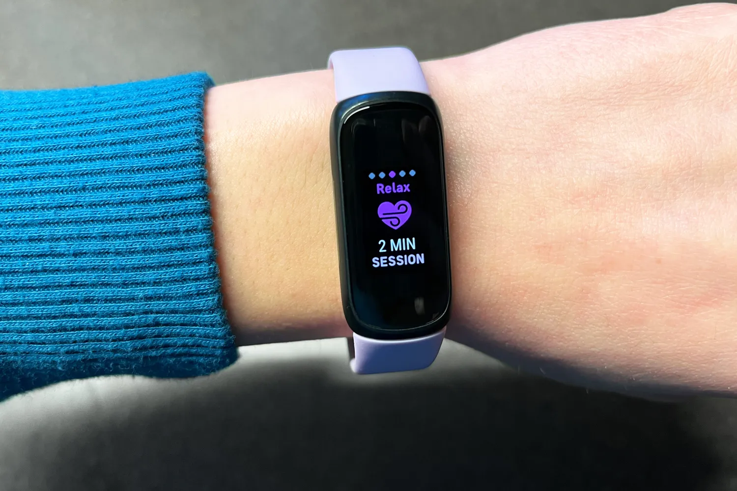 A fitness tracker screen showing a two-minute guided relaxation session with a heart icon.