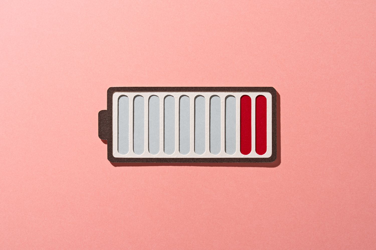 Minimalist illustration of a nearly empty red battery icon on a light background.