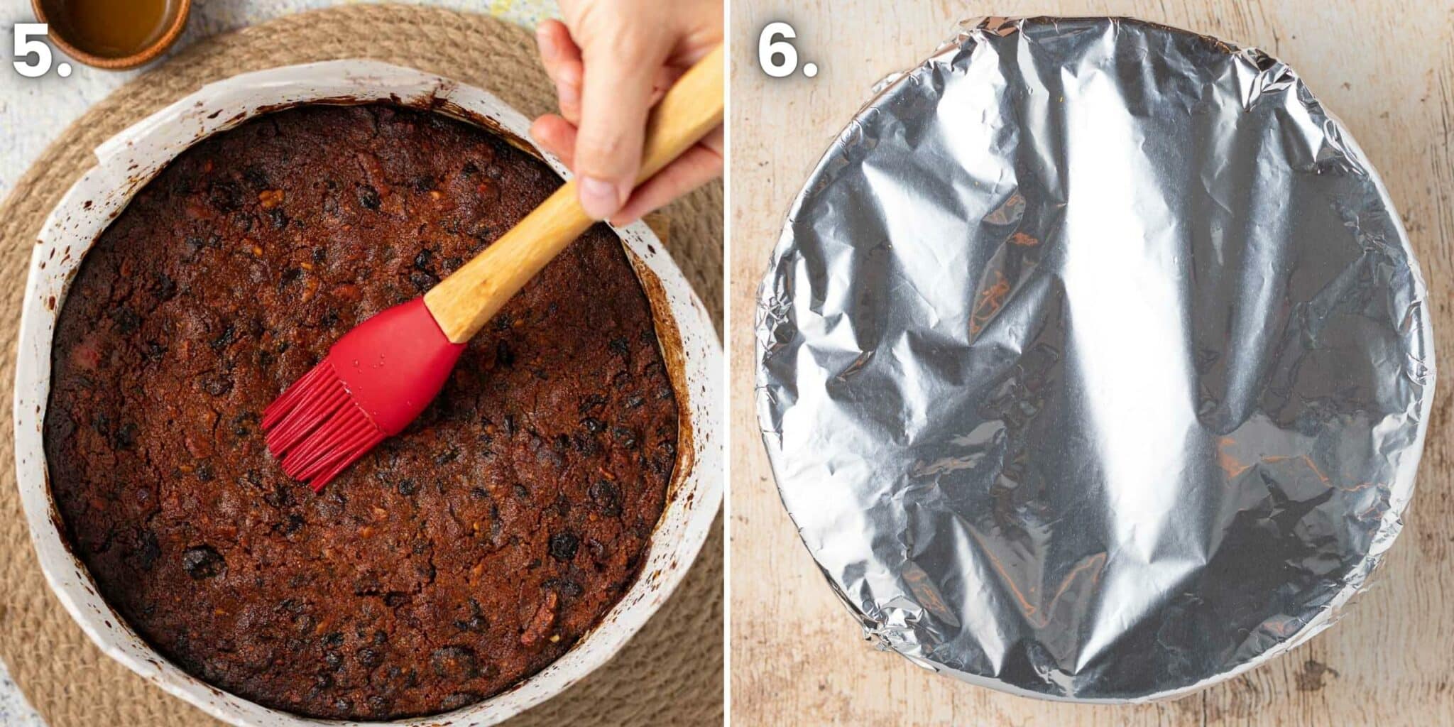 A hand brushing brandy onto the top of a freshly baked vegan fruit cake.