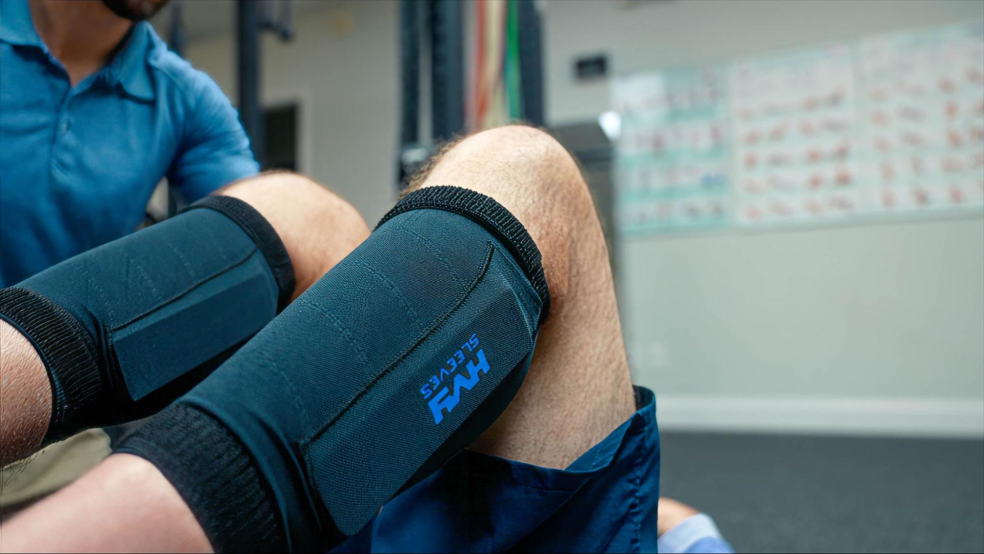 A person performing a physical therapy leg lift with weighted sleeves