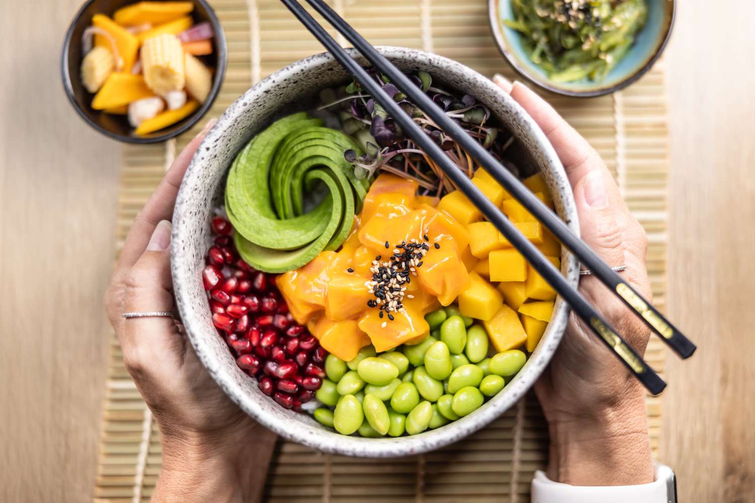 A colorful poke bowl with fresh mango, avocado, and edamame, representing a healthy meal choice during weight management.