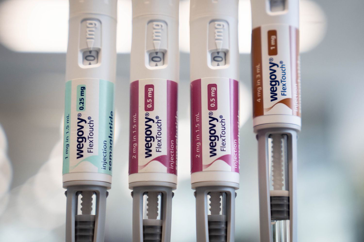 Four Wegovy injection pens of different doses arranged on a clean surface.
