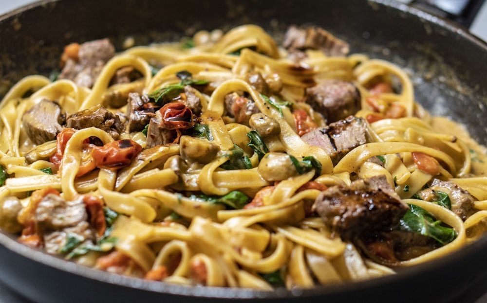 A large plate of spaghetti pasta drizzled with olive oil.