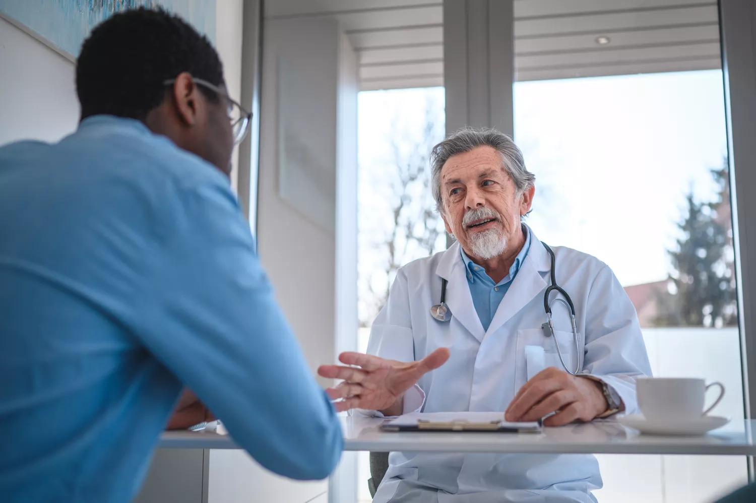 Man talking to a doctor in a clinical setting