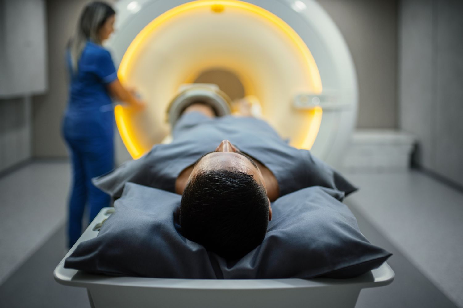 A technician preparing a patient for a diagnostic medical procedure.
