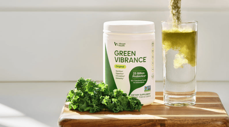Green Vibrance superfood powder container with a serving scoop.