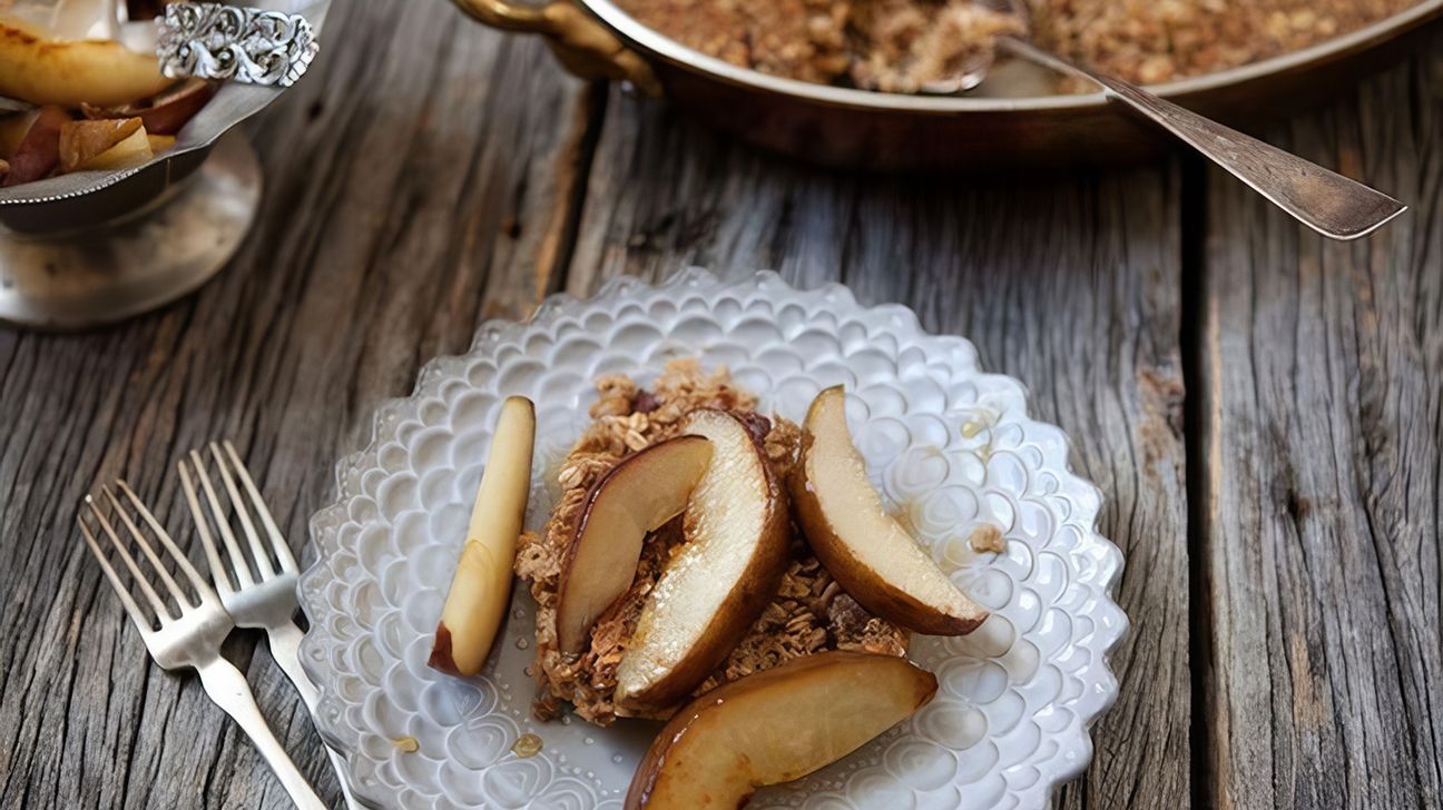 Golden-brown chai baked oatmeal topped with sliced pears in a white baking dish.