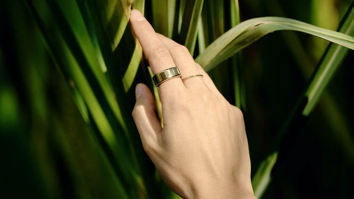 An Oura Ring Generation 3 in a metallic finish being worn on a finger.