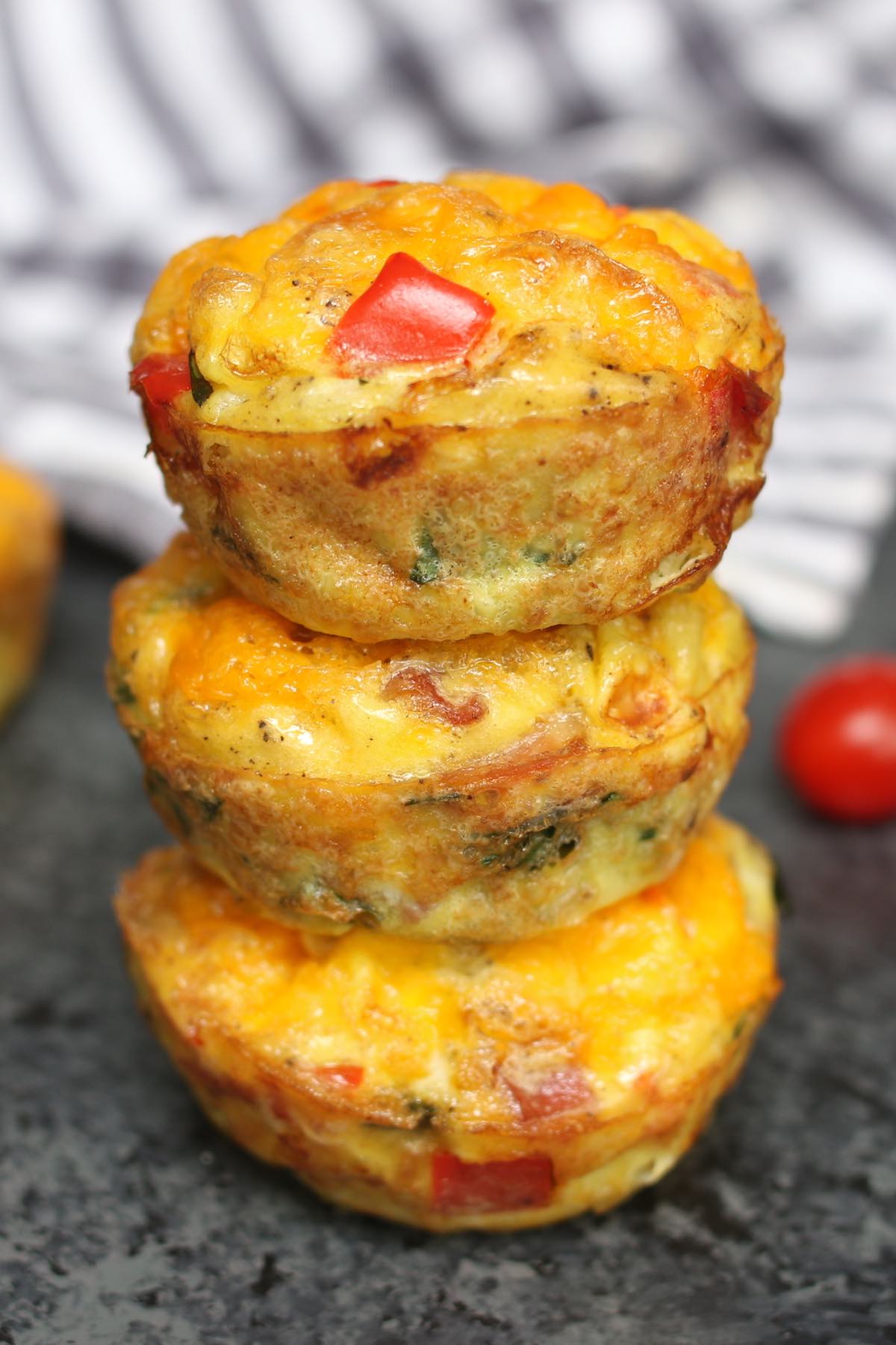 A collection of assorted healthy savoury breakfast muffins on a cooling rack.