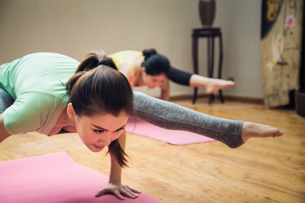 A group of people practicing gentle restorative yoga in a brightly lit studio.